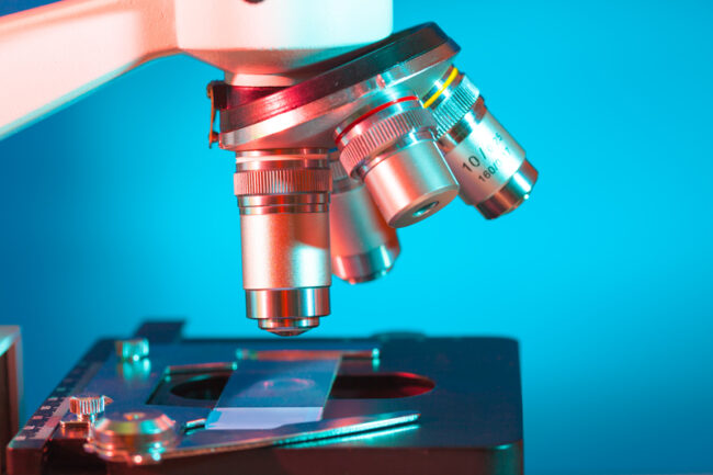 Medical professional Looking Through Microscope