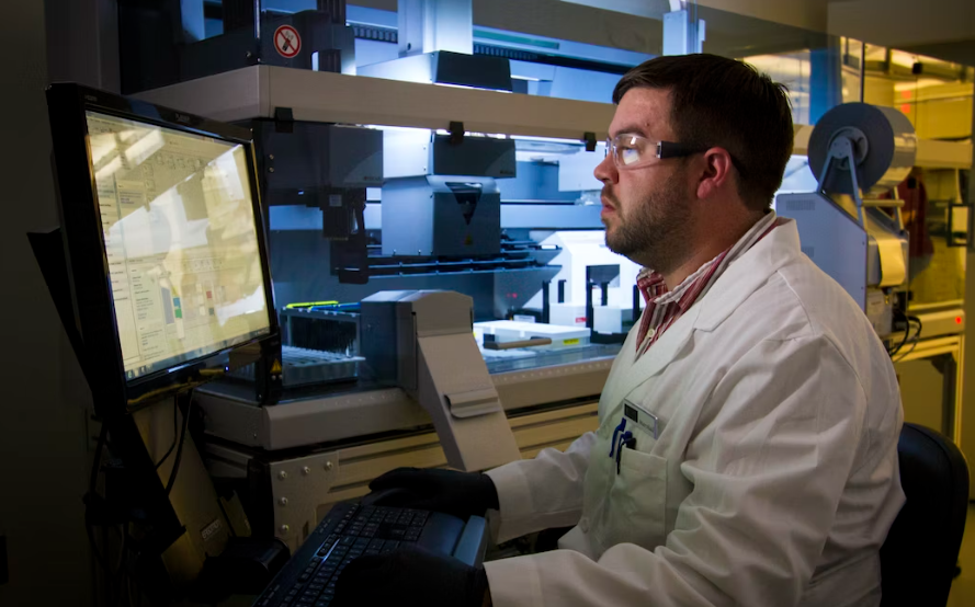 Scientist running data in a lab.