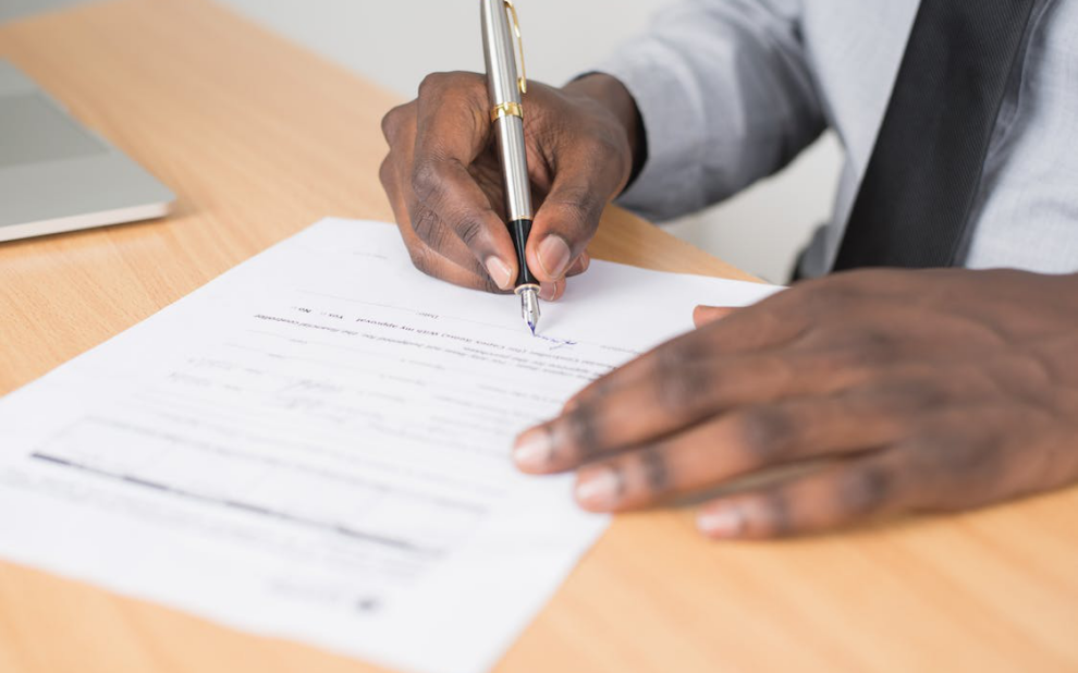a person signing a document.