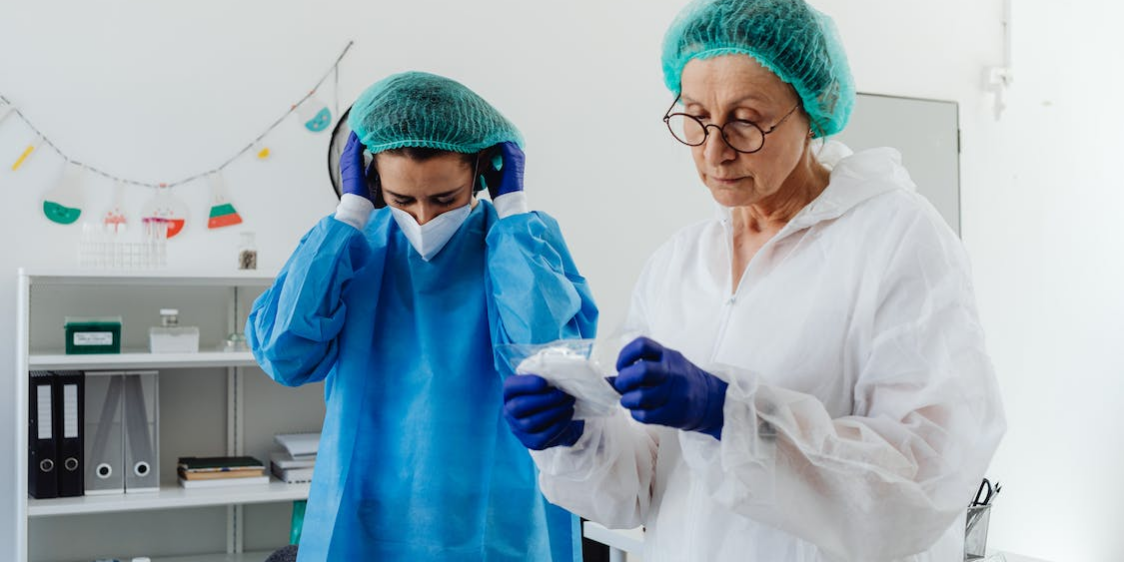 two medical researchers are preparing to wear face masks.