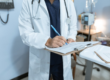 a doctor is writing a report.