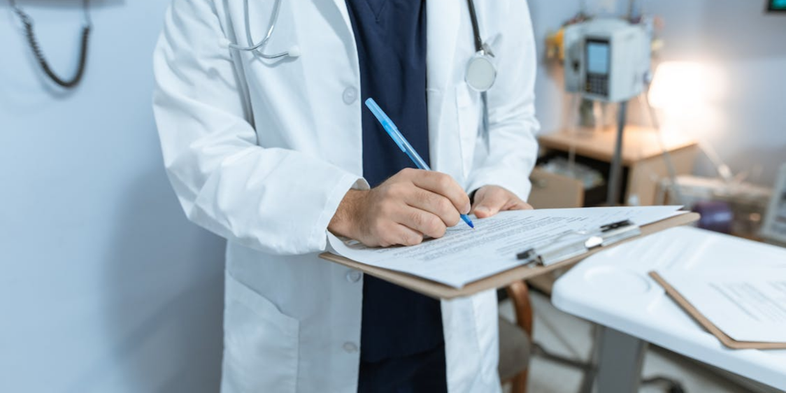 doctor-writing-report a doctor is writing a report.