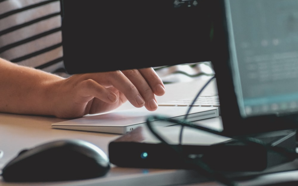 a person using a touchpad on a computer.